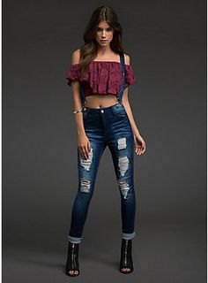 Burgundy off-the-shoulder top paired with blue ripped suspender jeans