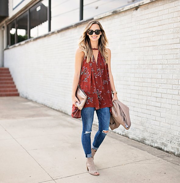 Red V-neck sleeveless tunic and blue ribbed skinny jeans