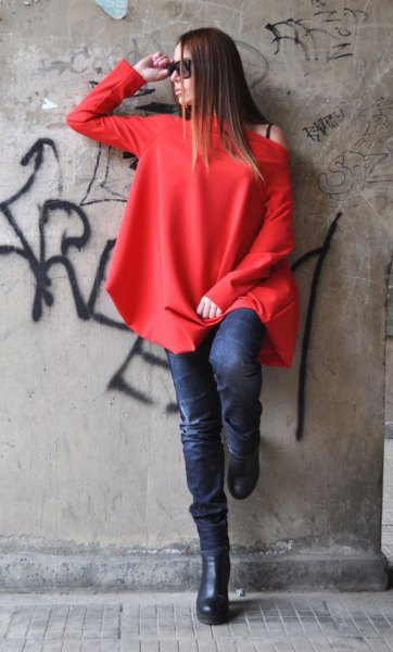 red long-sleeved one-shoulder top and dark blue skinny jeans
