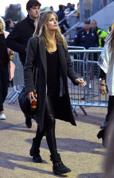 black longline wool coat with leather trousers and ankle boots