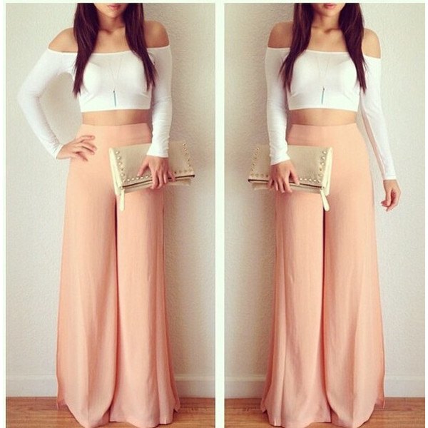 Pink trousers with a white, off-the-shoulder, figure-hugging top