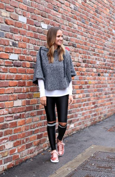 mottled gray sweater with knee-length drainpipe pants made of black leather