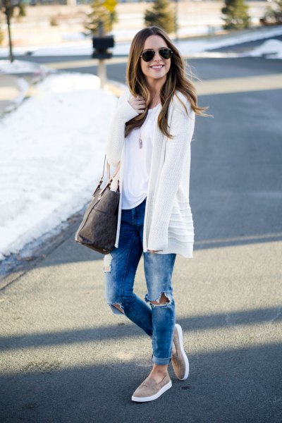 white cardigan with blue ripped jeans with cuffs and gray panties on hiking boots