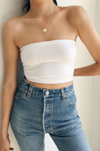 white cropped strapless top with blue skinny jeans