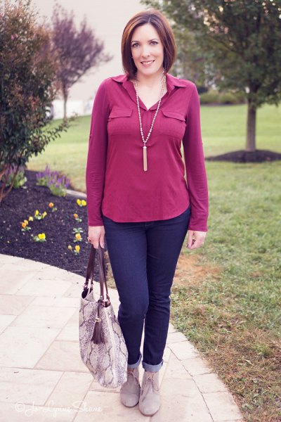 pink blouse with dark blue cuffed jeans and gray suede boots