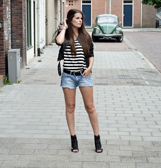 black and white striped t-shirt with a short leather jacket and denim shorts