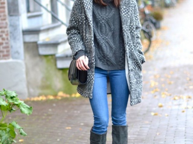 gray long sweater with light blue jeans and black knee high boots