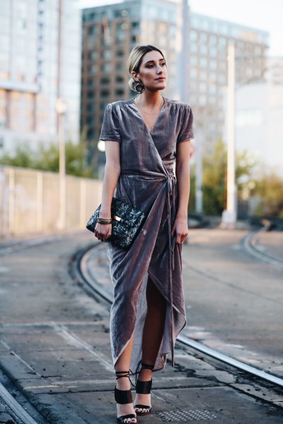 gray high low maxi dress with black clutch