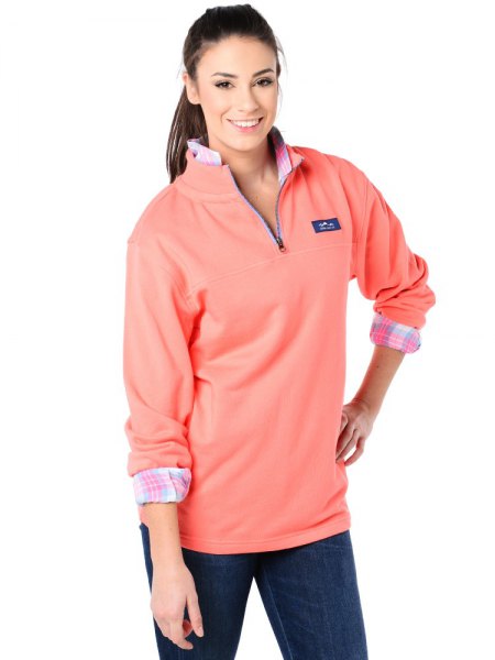 Blush pink long sleeve polo shirt worn with a gray and white plaid shirt