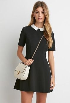 Black fit mini dress with flared collar and white leather handbag