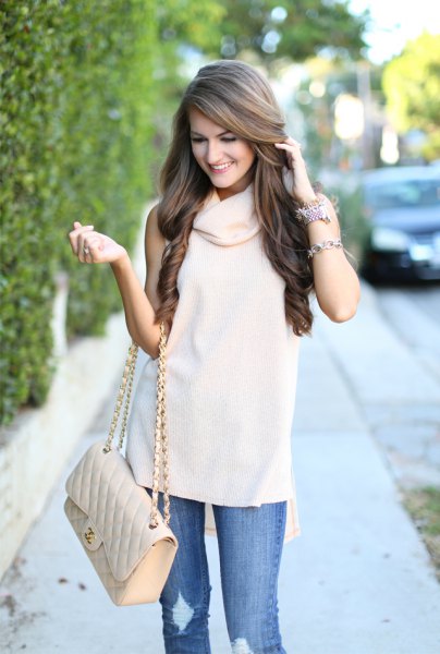 White cowl neck sleeveless sweater, ripped jeans