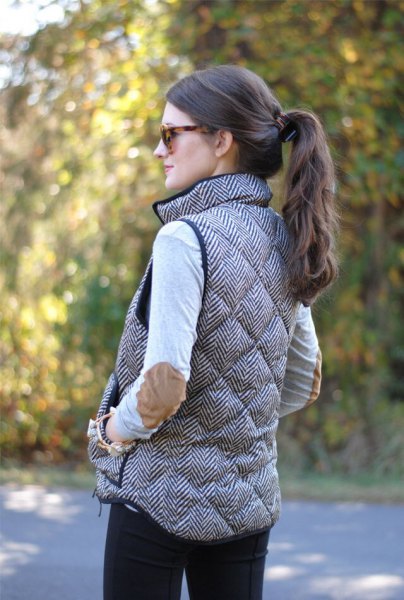 gray quilted long down vest with white bodice and patch elbows