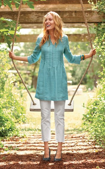 blue tunic top with three-quarter sleeves and gathered waist and white cropped pants