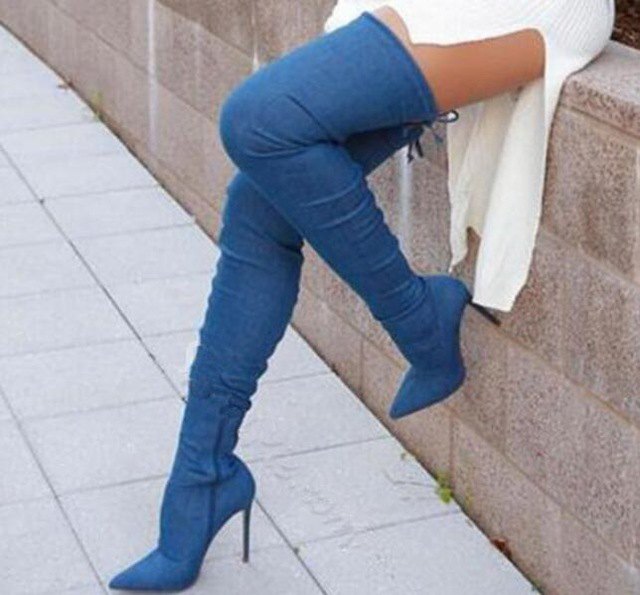 white ribbed sweater dress with high-heeled denim boots