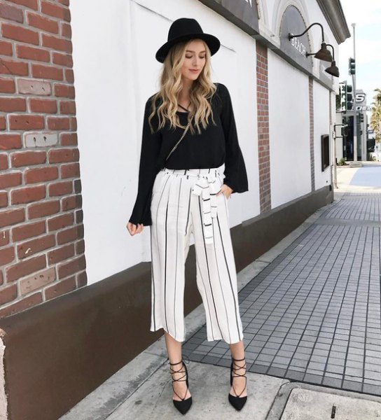 black sweater with white cropped pants with wide legs
