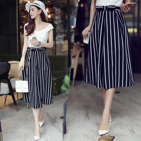 cropped black and white striped pants with wide legs and a white felt hat