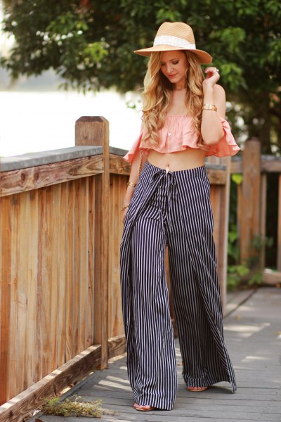 Blush pink sleeveless ruffle top with black and white striped pants