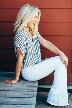 gray and white striped short-sleeved shirt with wide sleeves and bell bottom jeans