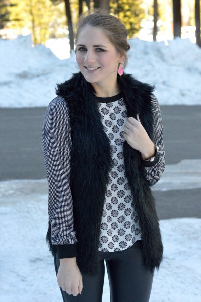 black vest with tribal printed long sleeve top and dark gray jeans