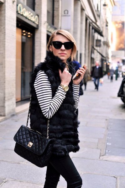 white and black striped long-sleeved t-shirt with a fur vest and slim-fit jeans