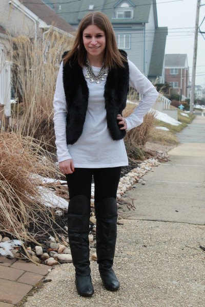 white long sleeve tunic top with black jeans and knee high leather boots