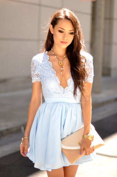 white, low-sleeved mini dress with a deep V-neckline and two toned laces