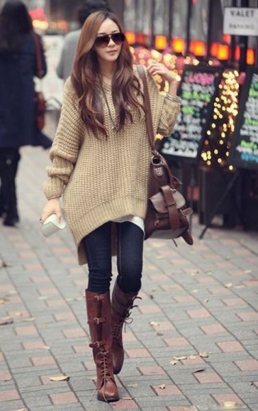 blush pink big sweater with dark blue skinny jeans and brown boots