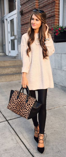 white ribbed large sweater with black leather leggings