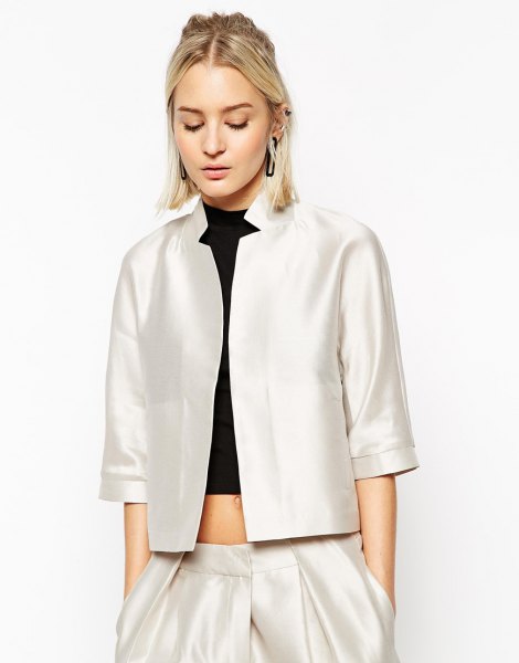 white silk jacket with three quarter sleeves and black crop top