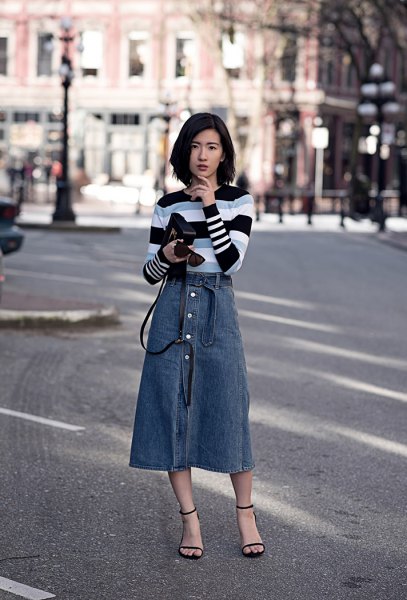 black gray and white striped sweater with blue midi button at front of skirt