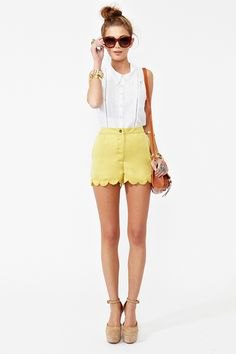 white sleeveless blouse with yellow scalloped mini shorts