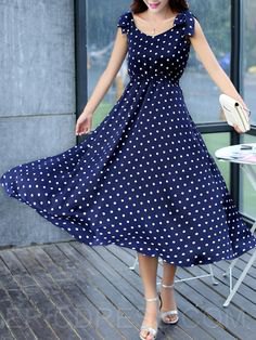 Navy blue polka dot maxi dress and flared maxi dress with silver heels