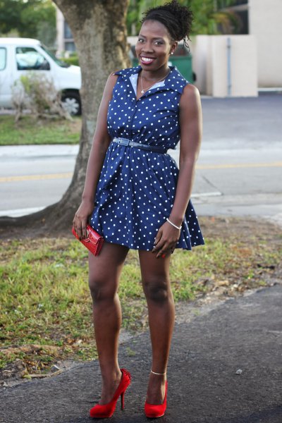 sleeveless mini dress with a blue polka dot belt and red heels