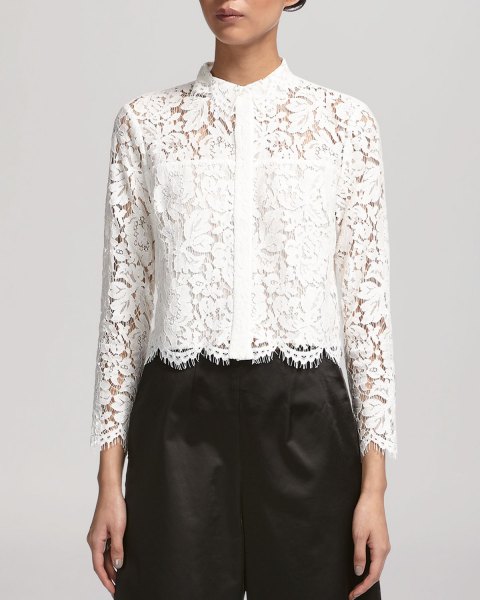 white lace shirt with scalloped hem, black pants
