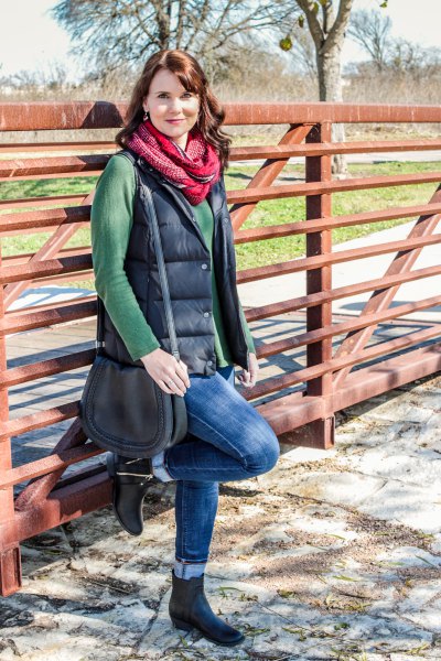 green cowl neck sweater and black quilted vest