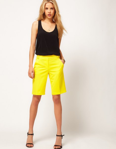 black sleeveless scoop neck tank top and yellow shorts