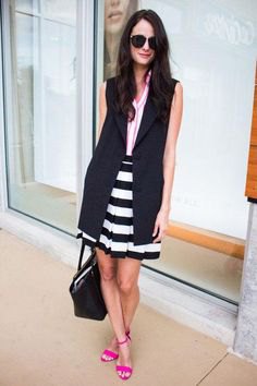 black sleeveless longline blazer with a striped mini skirt and open toe heels