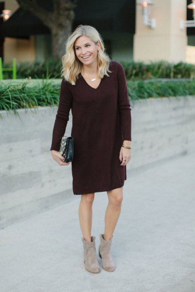 black knee-length V-neck shift sweater and gray boots