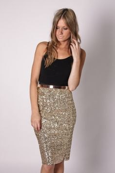 black scoop neck tank top and gold sequined knee length skirt