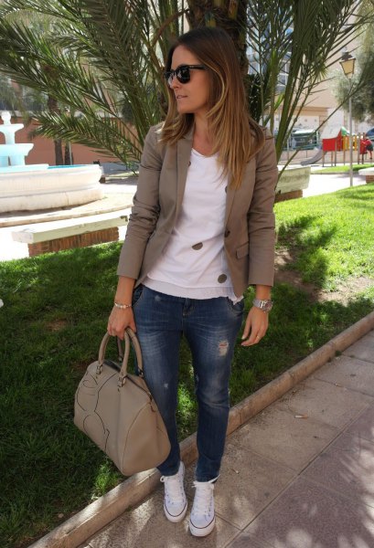Olive green khaki blazer with white sweater and blue jeans