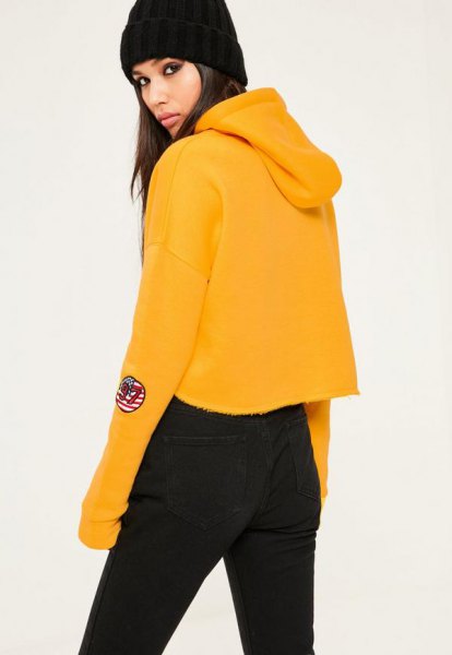 Mustard yellow cropped hoodie with black high waisted jeans