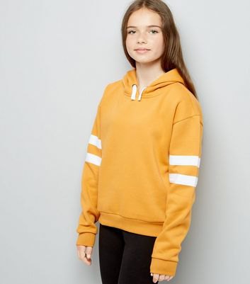 Mustard hoodie with white striped sleeves