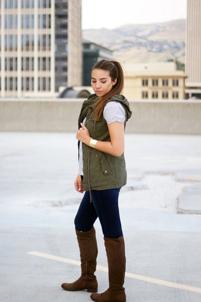 Hooded vest with a gray t-shirt and knee-high boots