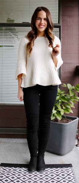 white ribbed sweater with black skinny jeans and leather boots