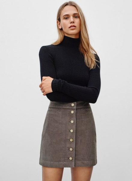 black bodycon turtleneck sweater with gray high waisted corduroy mini skirt