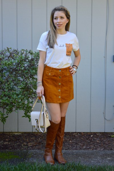 white printed t-shirt with green corduroy skirt and brown boots
