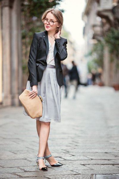 black blazer with gray pleated dress and black kitten heels with ankle straps