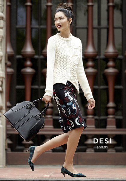 white knit sweater and black knee-length floral skirt