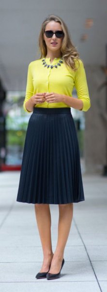 yellow half sleeve collarless blouse with pleated midi navy skirt