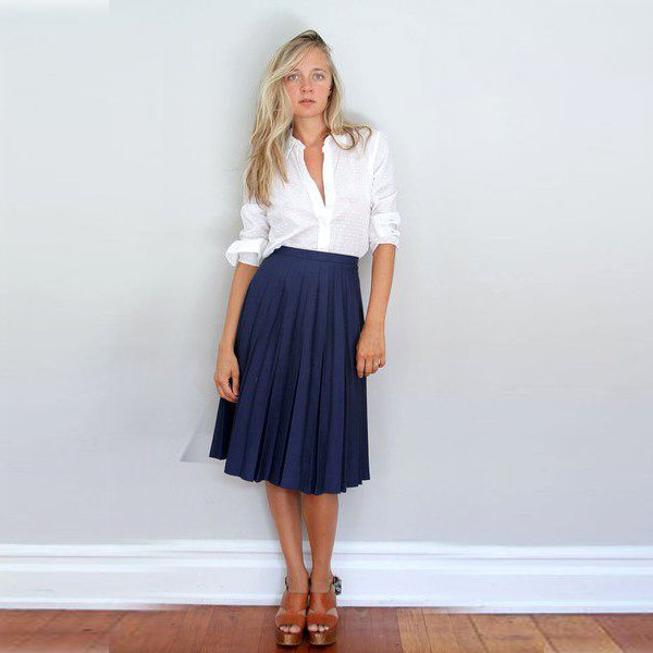 white button down shirt and dark blue pleated midi skirt